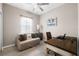 Functional office space with hardwood floors, a comfortable sofa, and plenty of natural light at 13475 Crest Lake Dr, Hudson, FL 34669