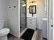 Bathroom showcasing a walk-in shower, modern vanity, and convenient washer/dryer at 1799 N Highland Ave # 143, Clearwater, FL 33755