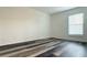 Bright bedroom showcasing a window with blinds and modern vinyl plank flooring throughout at 1799 N Highland Ave # 143, Clearwater, FL 33755