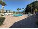 Enjoy the outdoors with a large rectangular pool and lounge seating, surrounded by mature palms at 1799 N Highland Ave # 143, Clearwater, FL 33755