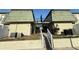 Building exterior showing stairs leading to second level, neutral paint and olive color metal roof at 1799 N Highland Ave # 143, Clearwater, FL 33755