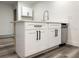 Stylish kitchen includes white shaker cabinets, quartz countertops, stainless dishwasher and sleek hardware at 1799 N Highland Ave # 143, Clearwater, FL 33755