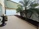 Private patio is surrounded by a white fence and palm trees with a grill at 1799 N Highland Ave # 143, Clearwater, FL 33755