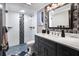 Modern bathroom with a walk-in shower, mosaic tile accents, and a marble-top vanity at 5036 Bonito Dr, New Port Richey, FL 34652