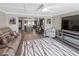 Open concept living room featuring hardwood floors, modern furniture, and seamless flow into the kitchen at 5036 Bonito Dr, New Port Richey, FL 34652