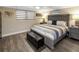 Comfortable bedroom with a queen-sized bed, wood laminate floors, and neutral decor at 5036 Bonito Dr, New Port Richey, FL 34652