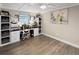 Bright office space with built-in shelving, a comfortable desk chair, and wood laminate flooring at 5036 Bonito Dr, New Port Richey, FL 34652