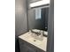 Modern bathroom featuring a clean white vanity, stylish fixtures, and a sleek mirror, creating a fresh and functional space at 8702 El Portal Dr, Tampa, FL 33604