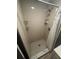 Updated bathroom featuring a stand-up shower with white subway tile and a decorative shower floor at 8702 El Portal Dr, Tampa, FL 33604