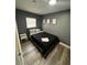 Well-lit bedroom with contemporary decor, sleek floors, and a cozy bed, creating a comfortable and stylish living space at 8702 El Portal Dr, Tampa, FL 33604