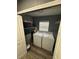 Dedicated laundry room with a washer and dryer; includes storage shelves and overhead lighting at 8702 El Portal Dr, Tampa, FL 33604