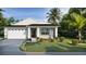 Charming single-story home boasting manicured landscaping, elegant stonework, and a welcoming two-car garage at 487 Sunset N Rd, Rotonda West, FL 33947