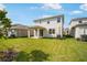 Backyard with lush lawn featuring rear elevation, patio and landscaping at 6018 Jensen View Ave, Apollo Beach, FL 33572