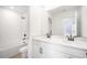 Modern bathroom featuring double vanity, white cabinetry, and a tub-shower combination with white tile surround at 6018 Jensen View Ave, Apollo Beach, FL 33572