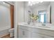 A well-lit bathroom featuring double sinks, white cabinets, and a shower-tub combination at 6018 Jensen View Ave, Apollo Beach, FL 33572