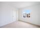 Bright bedroom featuring neutral carpeting, a window, and a door to the rest of the home at 6018 Jensen View Ave, Apollo Beach, FL 33572