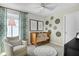 A cozy Bedroom with a crib, chair, rug, and playful wall decor at 6018 Jensen View Ave, Apollo Beach, FL 33572