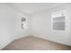 Bedroom featuring neutral walls and carpet, with two windows offering natural light at 6018 Jensen View Ave, Apollo Beach, FL 33572