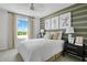 A light-filled bedroom with large window, and baseball themed decor at 6018 Jensen View Ave, Apollo Beach, FL 33572