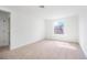 Bright bedroom with plush carpet, white walls, and a window offering natural light at 6018 Jensen View Ave, Apollo Beach, FL 33572