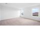 Spacious bedroom with neutral carpet and two large windows providing plenty of natural light at 6018 Jensen View Ave, Apollo Beach, FL 33572
