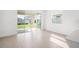 Bright dining room with sliding glass doors leading to the backyard and light wood-look tile flooring at 6018 Jensen View Ave, Apollo Beach, FL 33572
