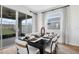 Elegant dining room with a modern table setting, sliding glass doors for outdoor access, and contemporary décor at 6018 Jensen View Ave, Apollo Beach, FL 33572
