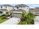 Two-story home featuring an attached garage, stone accents, and landscaping at 6018 Jensen View Ave, Apollo Beach, FL 33572