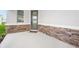 Welcoming front porch with decorative stone accents and a modern door at 6018 Jensen View Ave, Apollo Beach, FL 33572