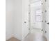 Hallway leading to a bathroom featuring modern doors and fixtures at 6018 Jensen View Ave, Apollo Beach, FL 33572