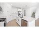 Contemporary kitchen featuring white cabinets, stainless steel appliances, and an island with sink and dishwasher at 6018 Jensen View Ave, Apollo Beach, FL 33572