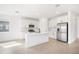 Bright, modern kitchen with stainless steel appliances, white cabinetry and a center island with a sink at 6018 Jensen View Ave, Apollo Beach, FL 33572