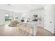 Open kitchen with a center island, white cabinets, and stainless steel appliances at 6018 Jensen View Ave, Apollo Beach, FL 33572