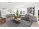 Stylized living room showcasing modern decor, comfortable seating, and natural light from large windows at 6018 Jensen View Ave, Apollo Beach, FL 33572