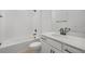 Spotless bathroom featuring a tub, shower, white vanity, and sleek black fixtures at 6026 Jensen View Ave, Apollo Beach, FL 33572