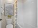 Cozy bathroom featuring a bathtub, patterned shower curtain, and a decorative print on the wall at 6026 Jensen View Ave, Apollo Beach, FL 33572