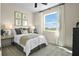 Bright bedroom featuring a comfortable bed, stylish decor, and ample natural light at 6026 Jensen View Ave, Apollo Beach, FL 33572