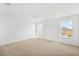 Bright and airy bedroom with two windows, neutral paint, and tan carpet flooring at 6026 Jensen View Ave, Apollo Beach, FL 33572