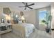 Well-lit bedroom featuring a comfortable bed, stylish decor, and a picturesque outdoor view at 6026 Jensen View Ave, Apollo Beach, FL 33572