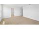 Spacious bedroom featuring neutral paint, carpeted flooring, and a large doorway at 6026 Jensen View Ave, Apollo Beach, FL 33572