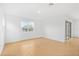 Bright room with wood-look tile floor, window, and sliding glass door at 6026 Jensen View Ave, Apollo Beach, FL 33572