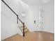 Bright entryway featuring wood floors, staircase with white railings, and a glass front door at 6026 Jensen View Ave, Apollo Beach, FL 33572
