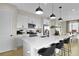 Open kitchen with a large island, stainless steel appliances, and sleek pendant lighting at 6026 Jensen View Ave, Apollo Beach, FL 33572