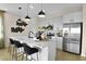 Modern kitchen with stainless steel appliances, a spacious island, and pendant lighting at 6026 Jensen View Ave, Apollo Beach, FL 33572