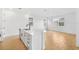 Bright kitchen island area with stainless steel dishwasher and hardwood style flooring at 6026 Jensen View Ave, Apollo Beach, FL 33572