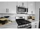 Updated kitchen with stainless appliances, white cabinets, and subway tile backsplash at 6026 Jensen View Ave, Apollo Beach, FL 33572