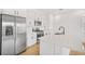 Modern kitchen boasts stainless steel appliances, white cabinetry, and quartz countertops at 6026 Jensen View Ave, Apollo Beach, FL 33572