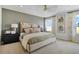 Comfortable main bedroom features a neutral color palette, soft textures, and two windows with bright natural light at 6034 Jensen View Ave, Apollo Beach, FL 33572