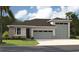 Charming single-story home with stone accents, three-car garage, and well-manicured lawn at 9136 Players Dr, Weeki Wachee, FL 34613