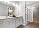 Modern bathroom featuring a double vanity, quartz countertop, and a glass-enclosed shower at 9156 Players Dr, Weeki Wachee, FL 34613